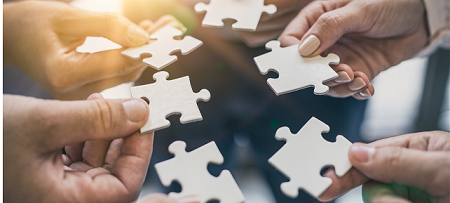 Image of hands holding puzzle pieces