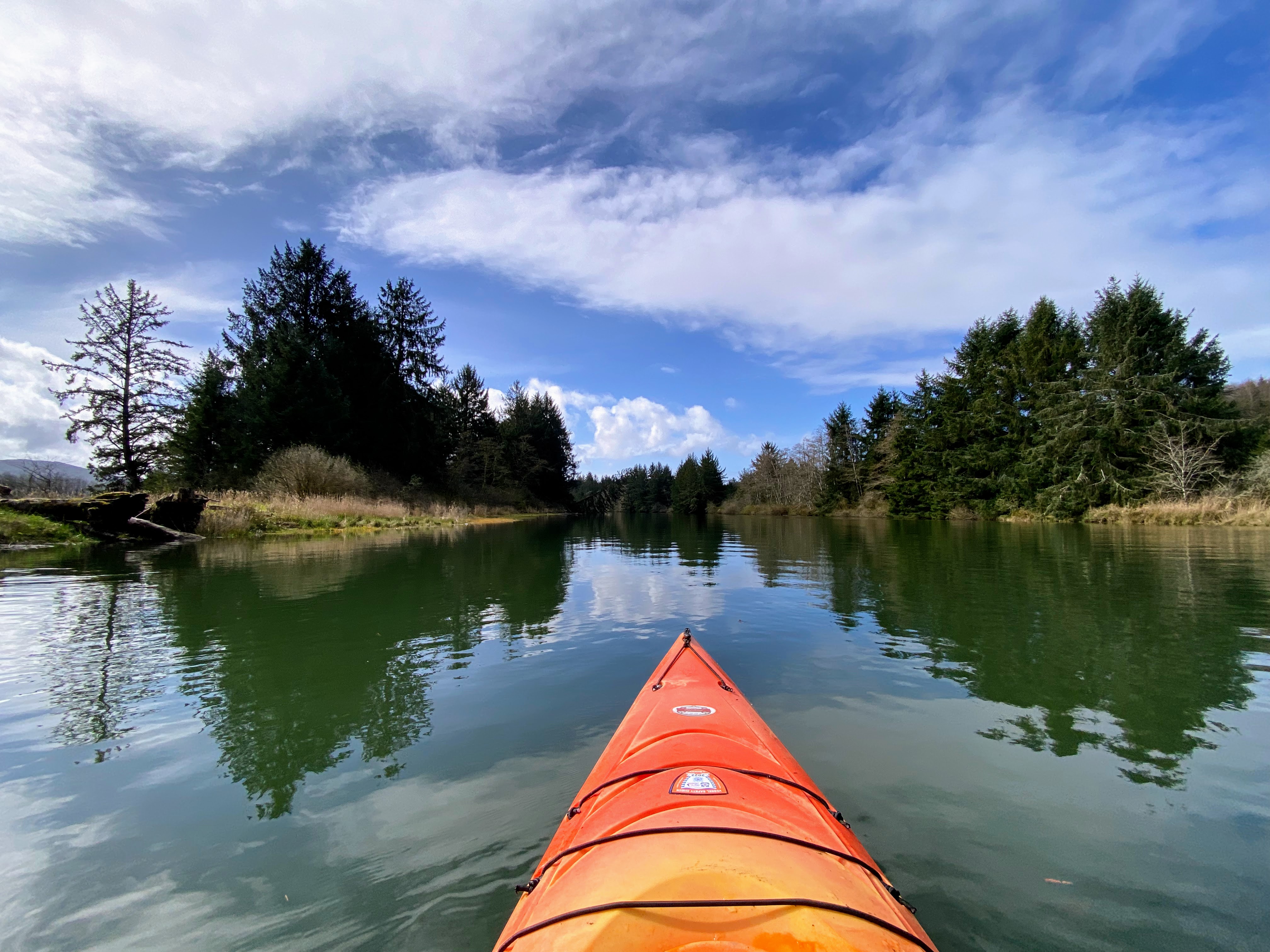 picture of a lake from the view of a kayak