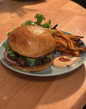 Genes burger on plate w/fries and sauce