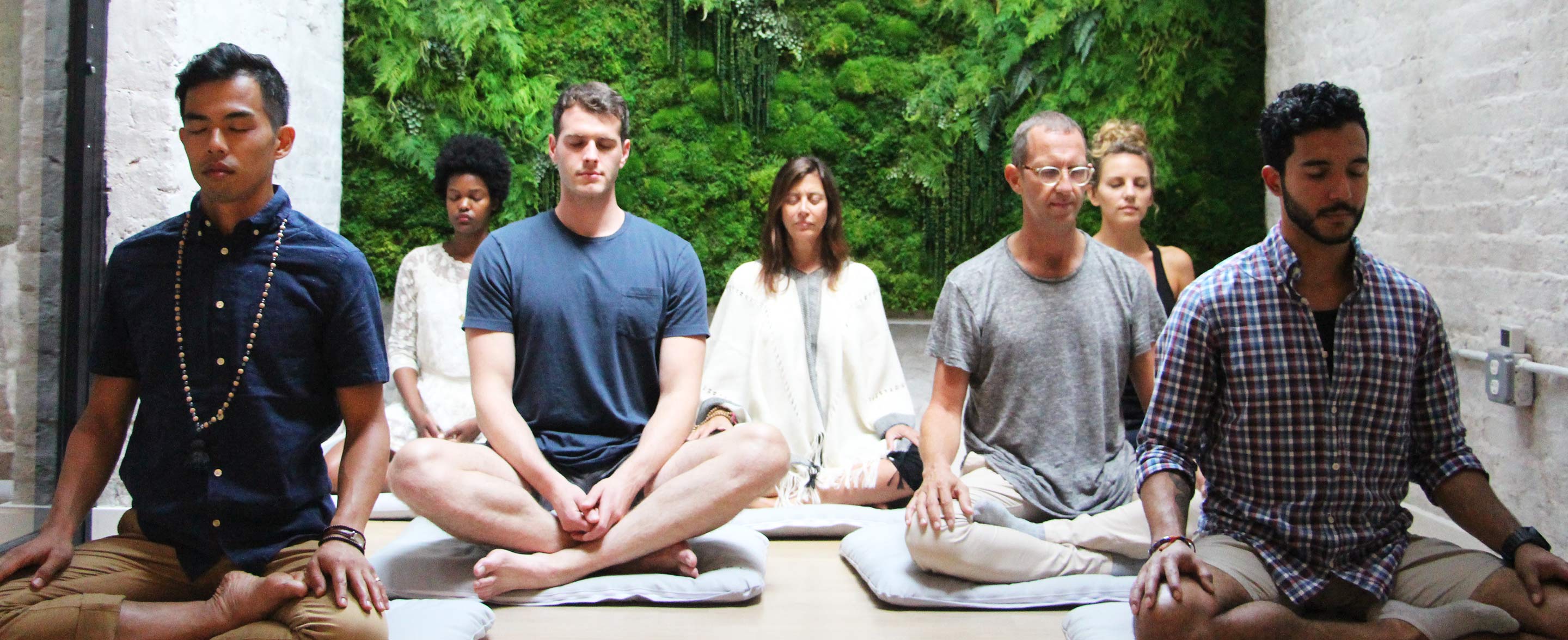 Group of men and women meditating together