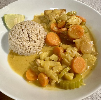 Pic of kelli's curry with ball of brown rice and lime wedge on dish