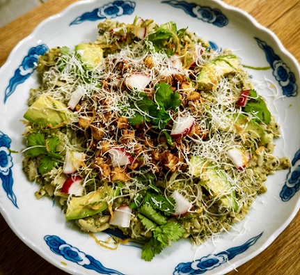 Orzo Mexicana con Esquites in white dish with blue decorative blue pattern. Colorful dish!