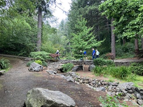 Handful of Sole Mates walking across bridge near Japanese Garden at Mingus Park