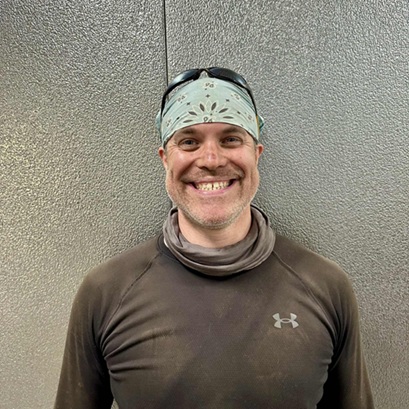 Josh smiling w/bandana and shades on head