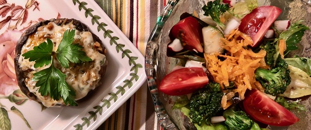 2 small dishes: one has stuffed portobello w/parsley garnish, other has salad w/lettuce, tomatoes, radishes, broccoli, etc.