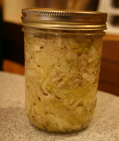 Closed glass jar of sauerkraut on table