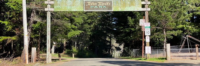 Pic of old entrance sign to Topits in the woods