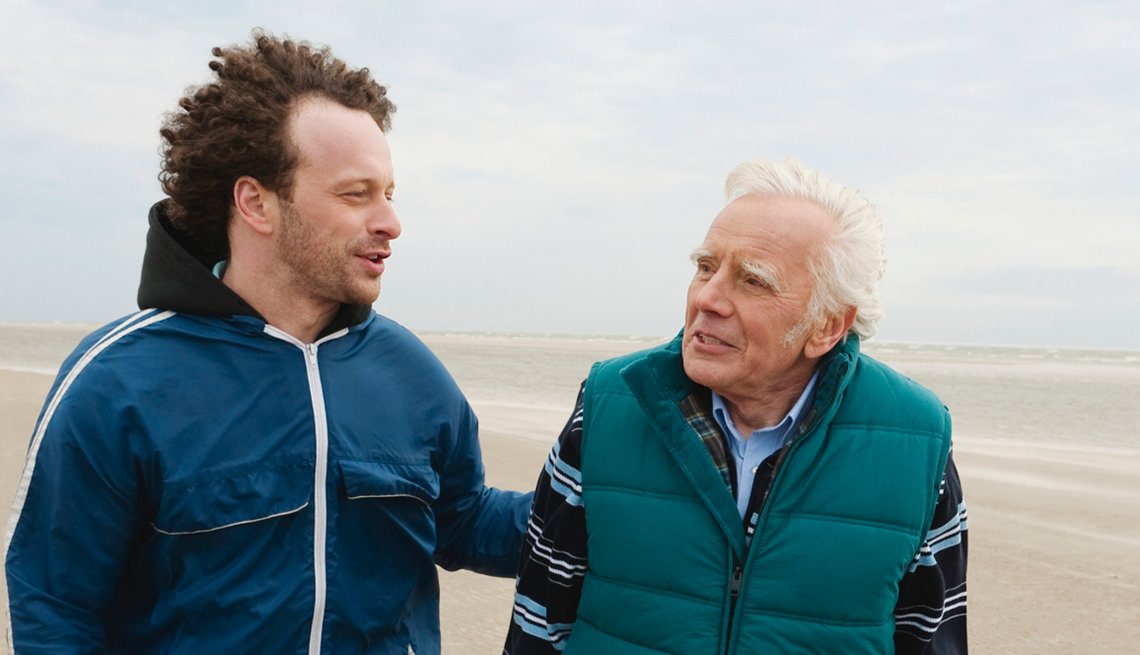 father & son talking on beach