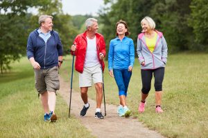 4 older adults walking, two women and two men
