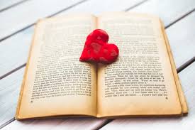 Open book with red heart on top.
