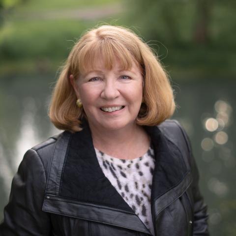 Author Photo of Kay from chest up, wearing black jacket