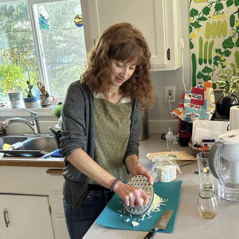 Kelli prepping a meal in her kitchen
