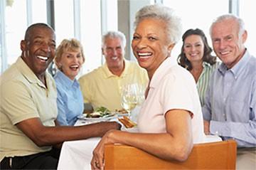 Group of senior sitting at a table smiling