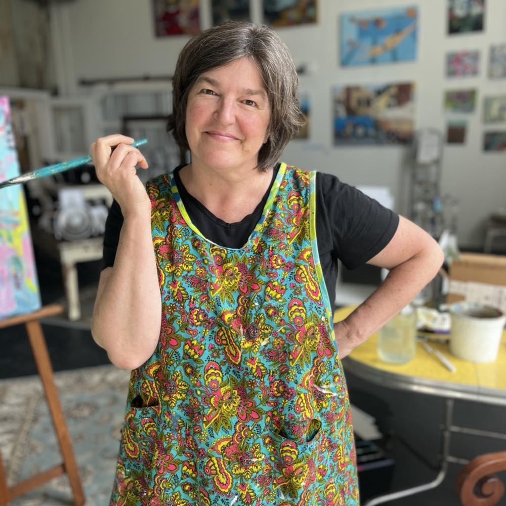 Josie holding paintbrush in art gallery